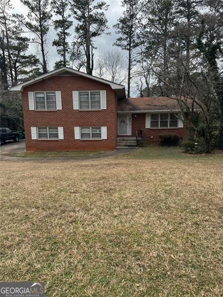 tri-level home with a front lawn