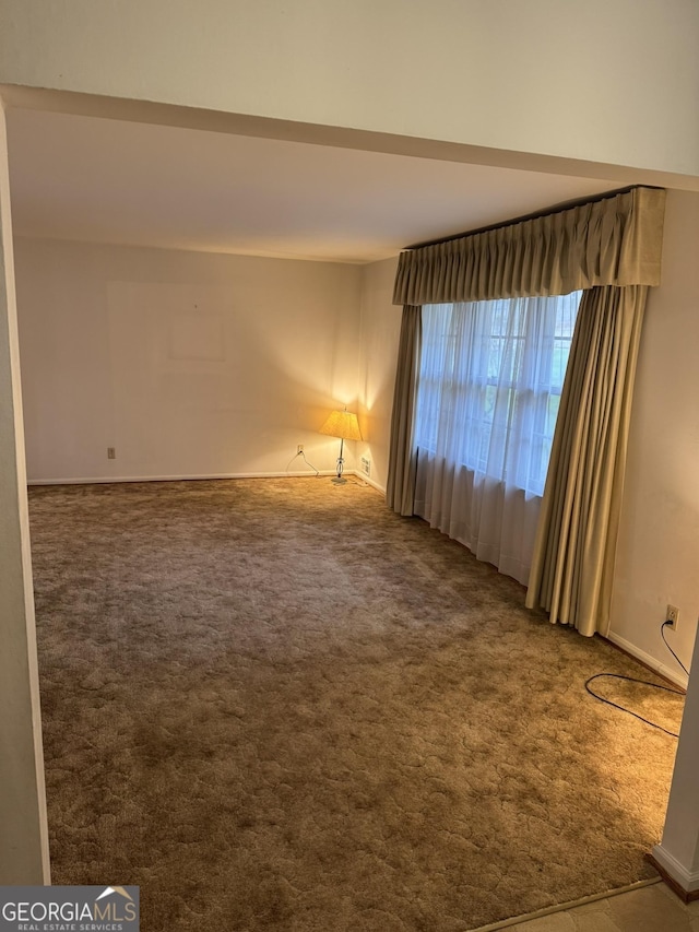 unfurnished room with carpet flooring