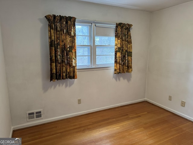 spare room featuring light hardwood / wood-style flooring