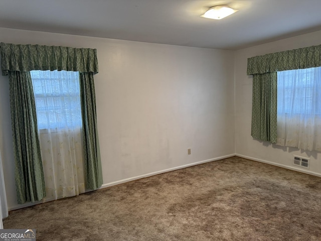 unfurnished room featuring carpet