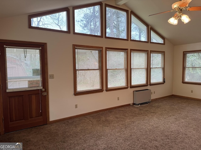 foyer with high vaulted ceiling, ceiling fan, and carpet