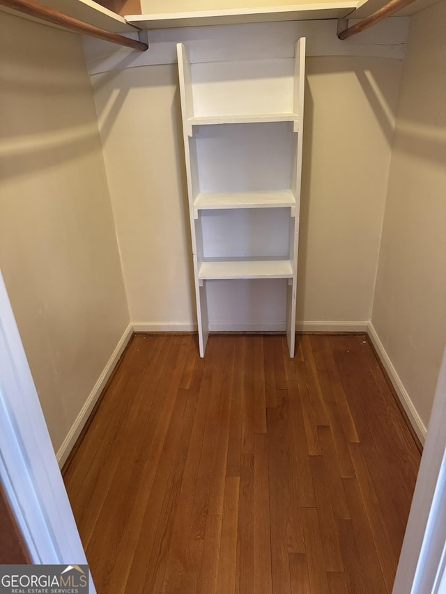 walk in closet with hardwood / wood-style floors