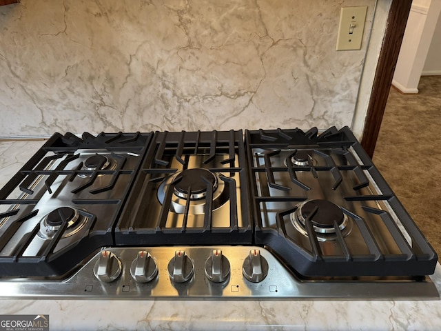 room details featuring gas stovetop and carpet flooring