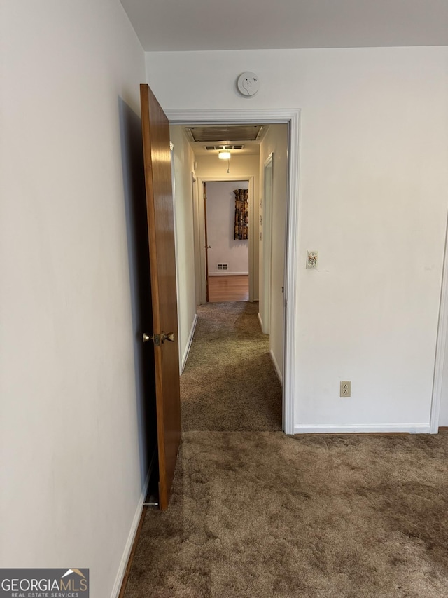 corridor with dark colored carpet