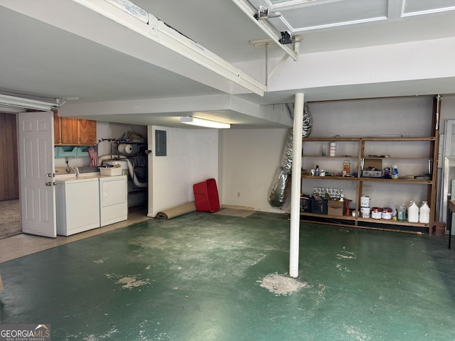 basement featuring electric panel and washer and dryer