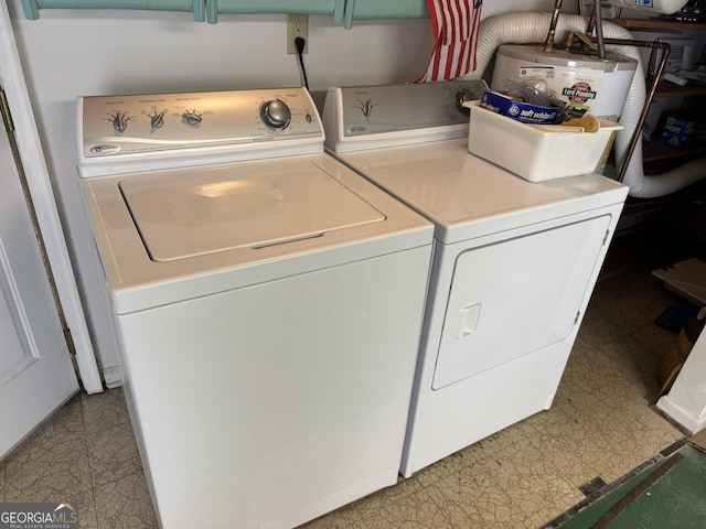 laundry area featuring separate washer and dryer and water heater