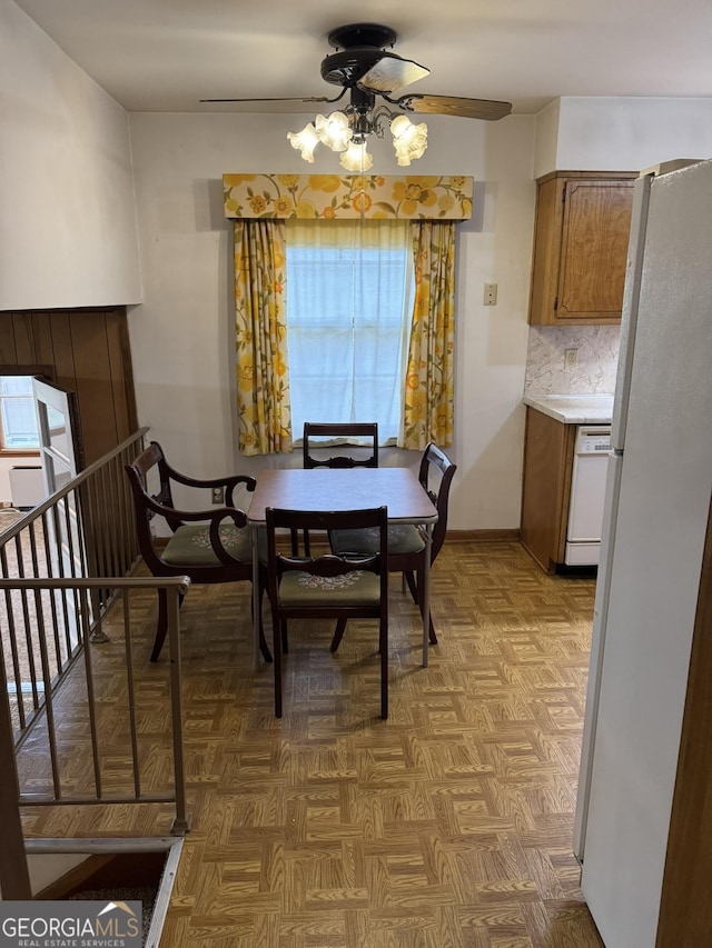 dining space featuring parquet floors and ceiling fan