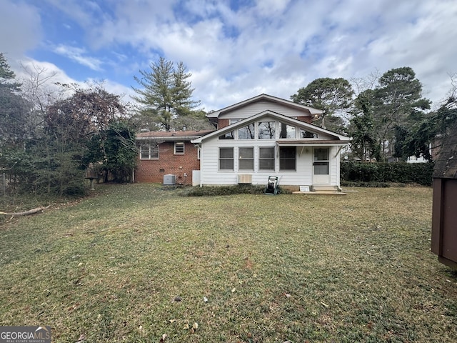 back of property featuring a lawn