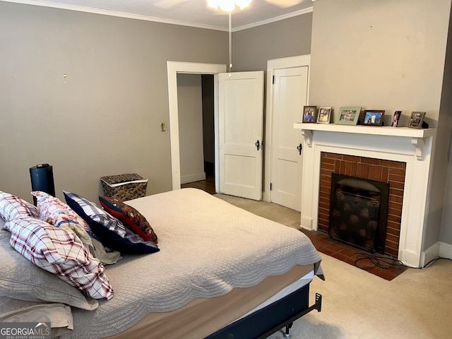 carpeted bedroom with crown molding and a brick fireplace