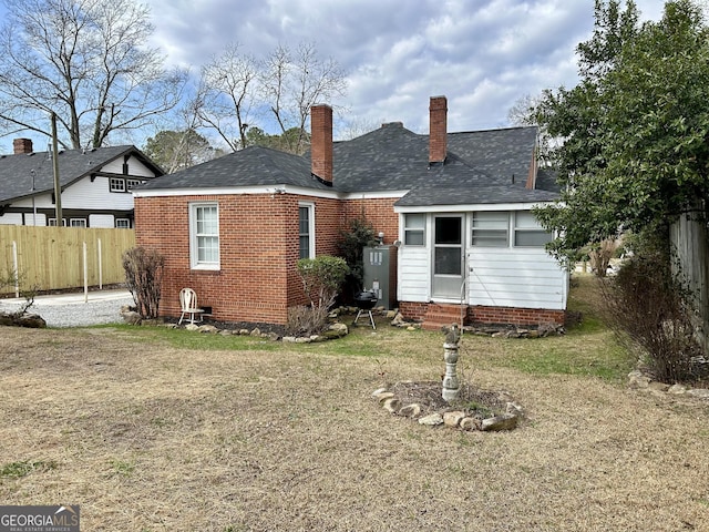 back of property with a yard and gas water heater