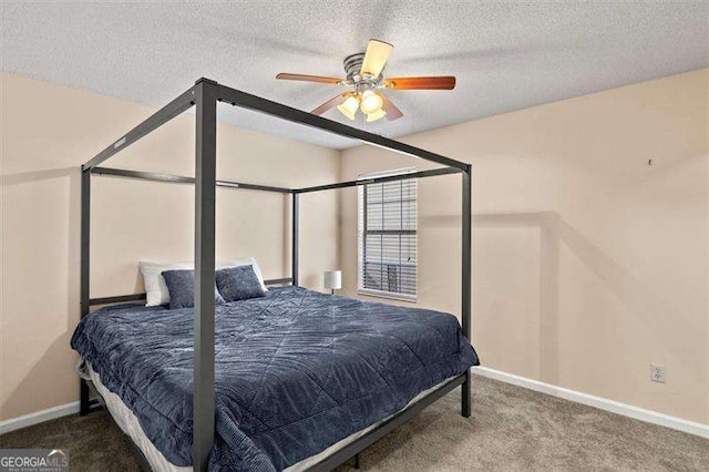 bedroom with ceiling fan, carpet flooring, and a textured ceiling