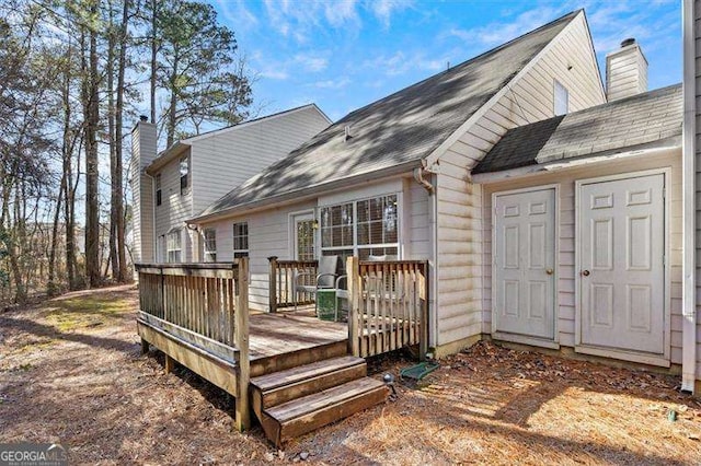 rear view of house featuring a deck