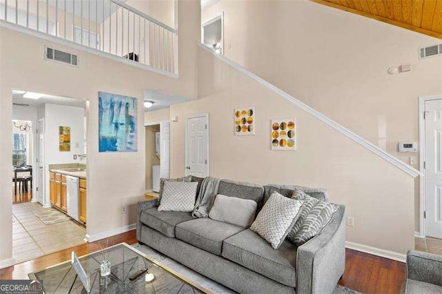 living room with wood-type flooring and a high ceiling