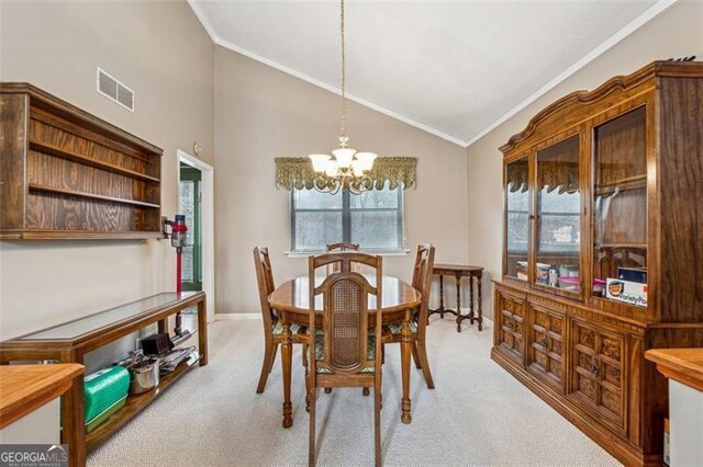 carpeted dining space with a healthy amount of sunlight, lofted ceiling, ornamental molding, and a notable chandelier