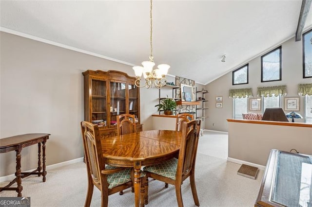 dining area featuring an inviting chandelier, light colored carpet, and high vaulted ceiling