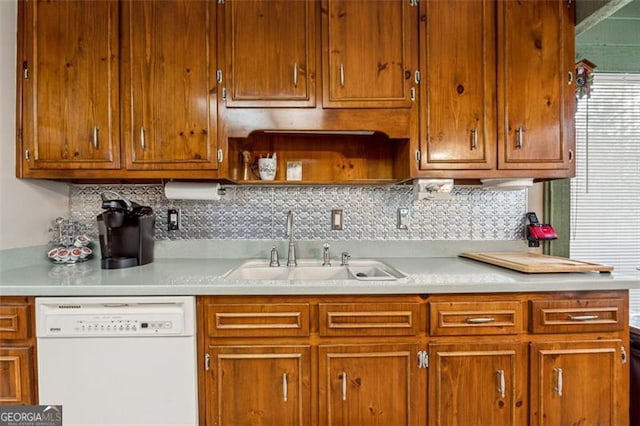 kitchen with tasteful backsplash, sink, and white dishwasher