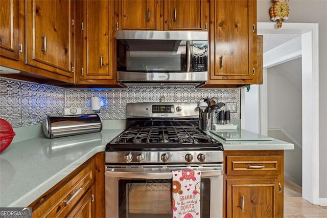 kitchen featuring decorative backsplash and appliances with stainless steel finishes