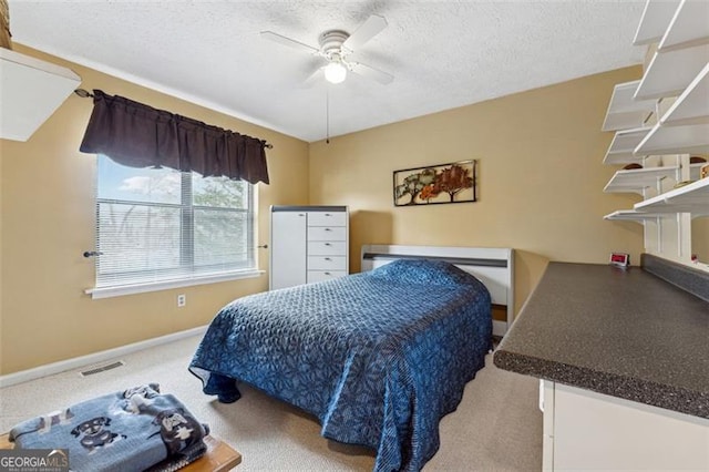 bedroom with ceiling fan and a textured ceiling