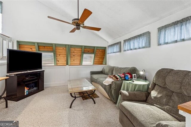 living room with light carpet, vaulted ceiling, and ceiling fan