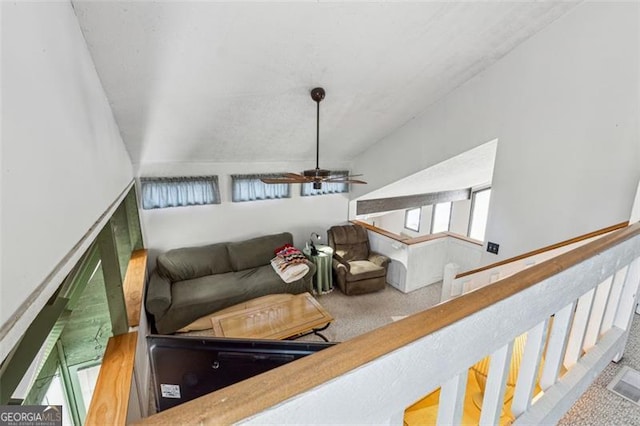 carpeted living room featuring ceiling fan and lofted ceiling