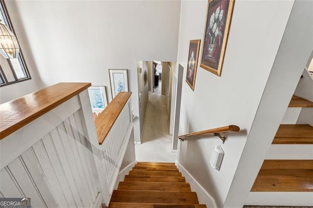 staircase with hardwood / wood-style floors