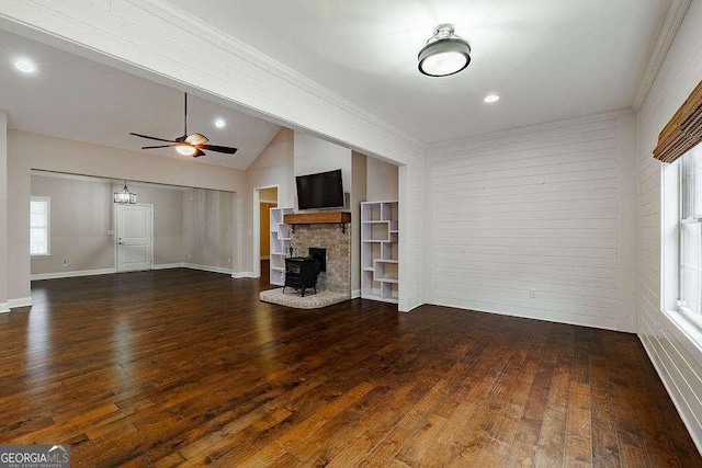 unfurnished living room with lofted ceiling, dark wood-style floors, ceiling fan, and crown molding