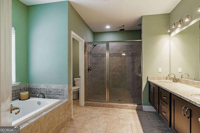 full bathroom featuring a garden tub, double vanity, toilet, a sink, and a shower stall