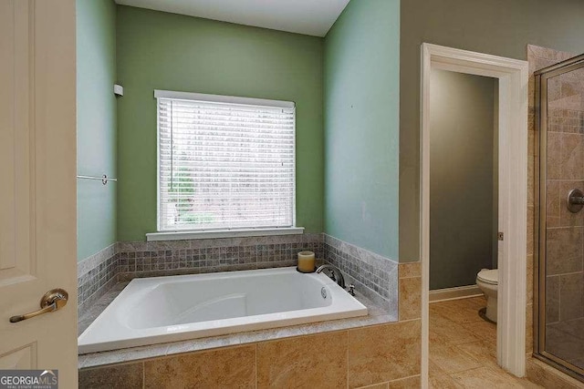 bathroom with tile patterned flooring, a shower stall, toilet, and a bath