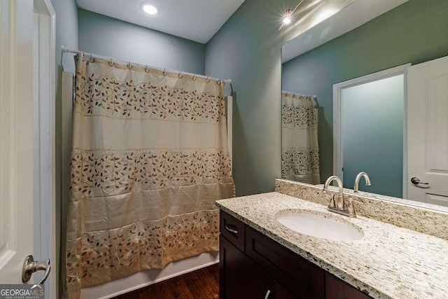 full bath with curtained shower and vanity