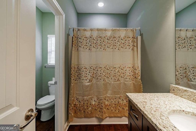 bathroom featuring vanity, toilet, and shower / bath combo with shower curtain