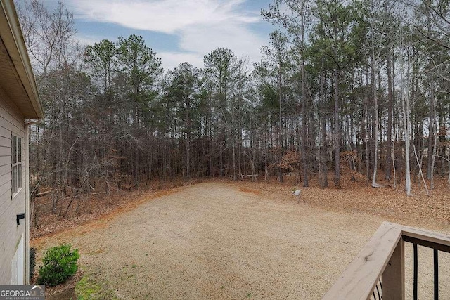 view of yard with dirt driveway