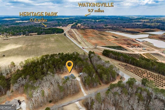 birds eye view of property with a rural view