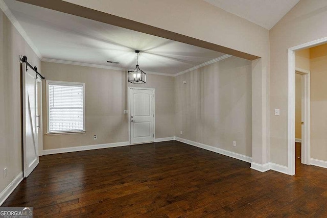 unfurnished dining area featuring dark wood-style floors, crown molding, visible vents, a barn door, and baseboards