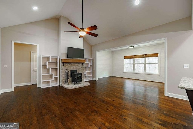 unfurnished living room featuring high vaulted ceiling, dark wood-style flooring, ceiling fan, and baseboards