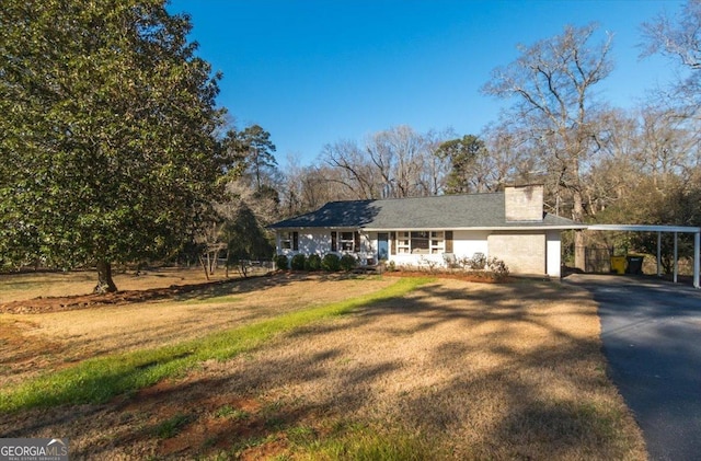 view of front of house featuring a carport and a front lawn