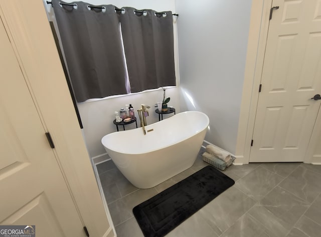 bathroom featuring tile patterned floors and a bathtub