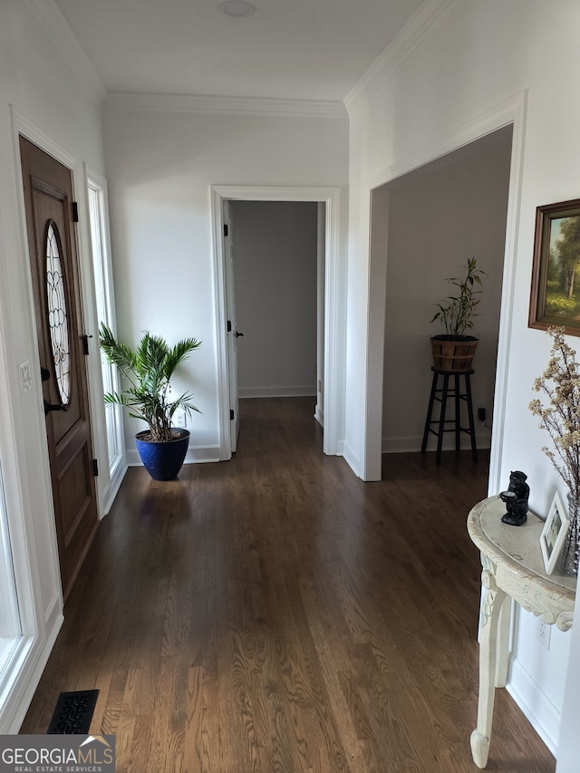 foyer featuring ornamental molding and dark hardwood / wood-style flooring