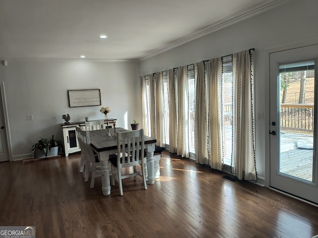 dining room featuring dark wood-type flooring and ornamental molding