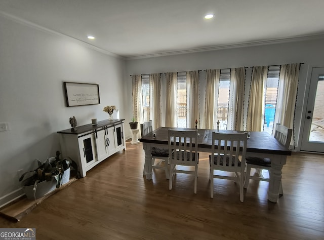 dining area with crown molding and dark hardwood / wood-style floors