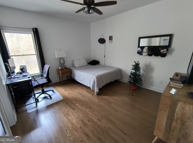 bedroom with ceiling fan and dark hardwood / wood-style flooring