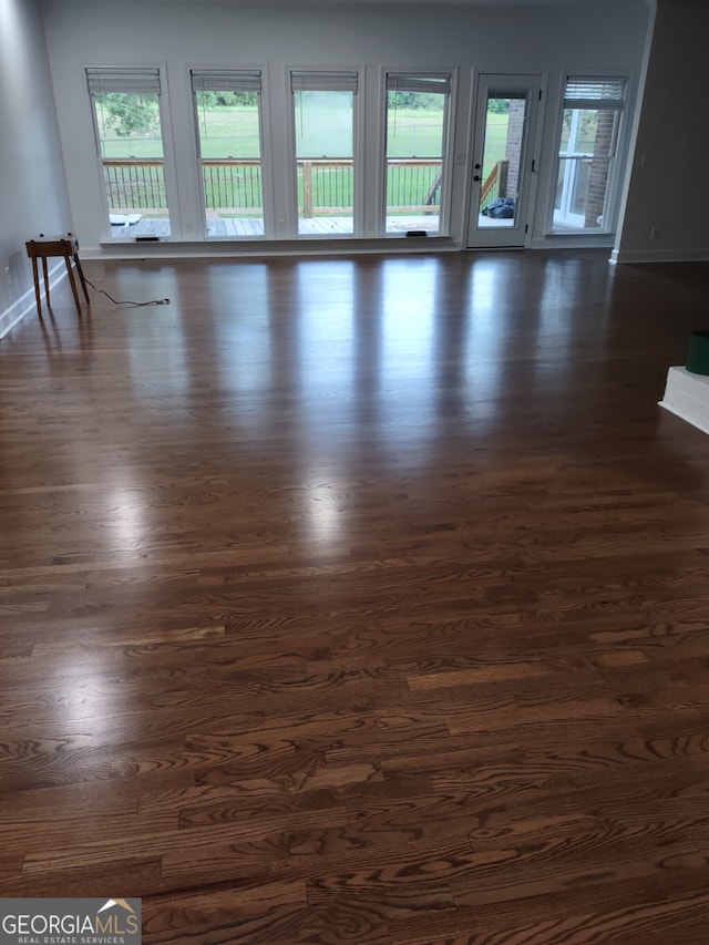 empty room with dark hardwood / wood-style floors