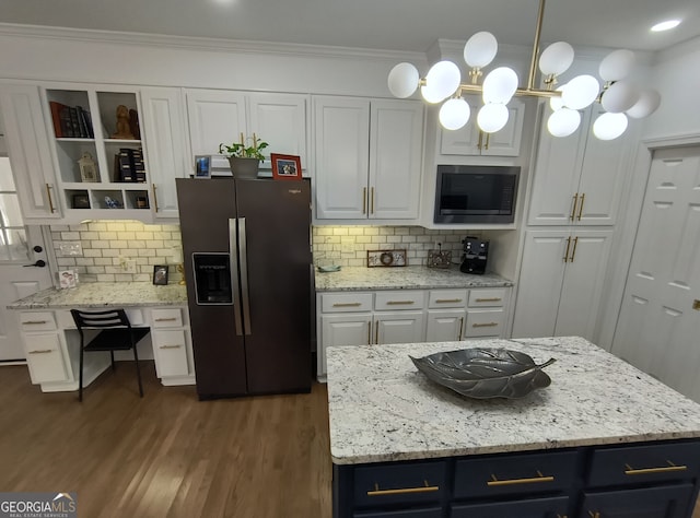 kitchen featuring pendant lighting, white cabinetry, a center island, built in microwave, and stainless steel fridge with ice dispenser