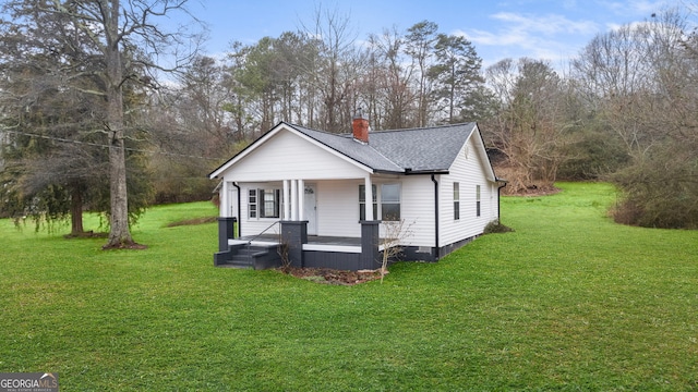 view of front of home with a front yard and a porch