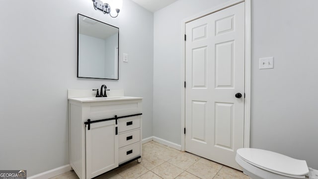 bathroom featuring tile patterned floors, vanity, and toilet