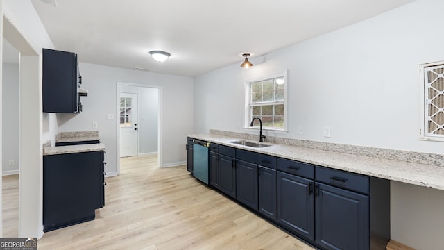 kitchen with blue cabinets, dishwasher, sink, and light hardwood / wood-style floors