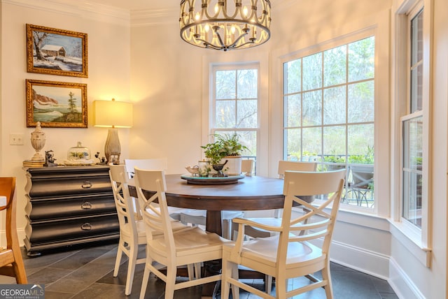 dining space featuring ornamental molding and a notable chandelier