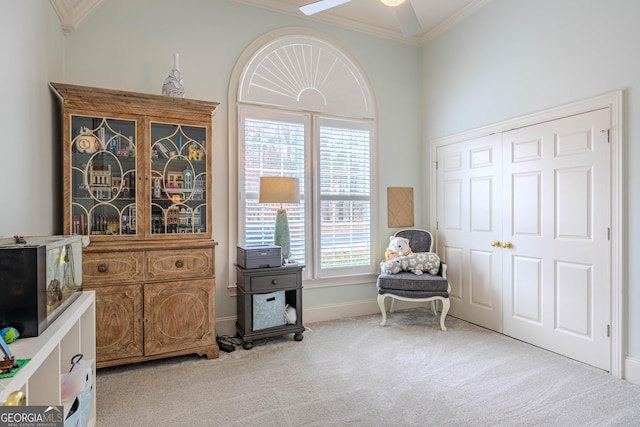 living area featuring crown molding, light colored carpet, and ceiling fan