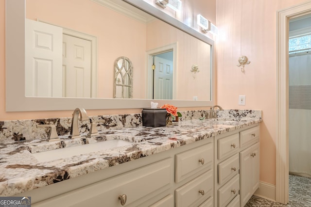 bathroom with vanity and ornamental molding