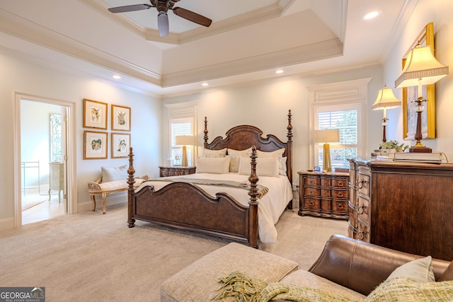 carpeted bedroom with ornamental molding, a raised ceiling, and ceiling fan