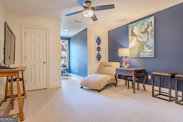 sitting room with light carpet, crown molding, and ceiling fan